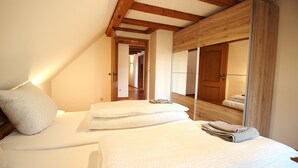 Une chambre à coucher avec un lit, un miroir et un plafond en bois.
