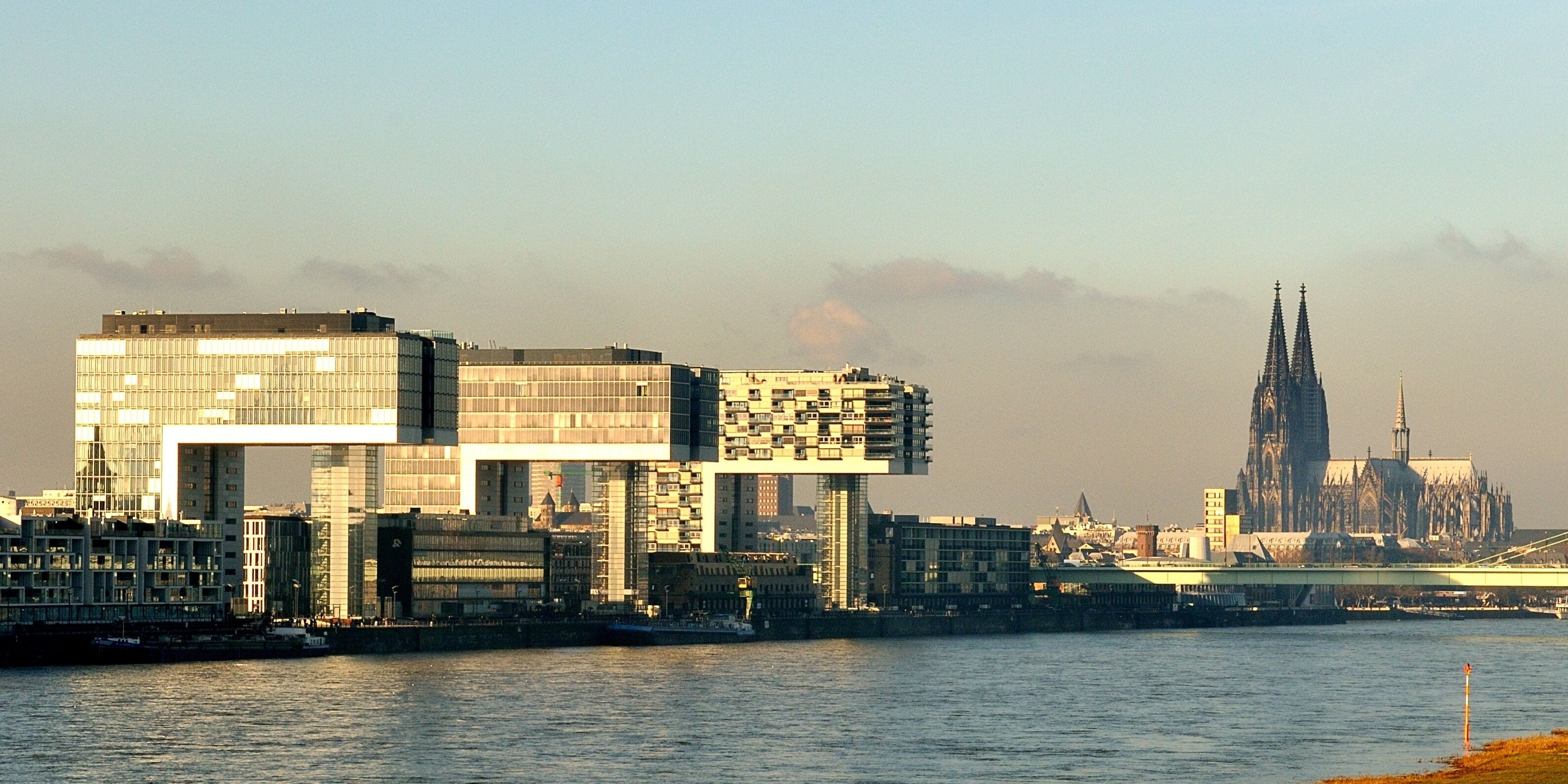 A cityscape with modern buildings and a historic cathedral in the background.