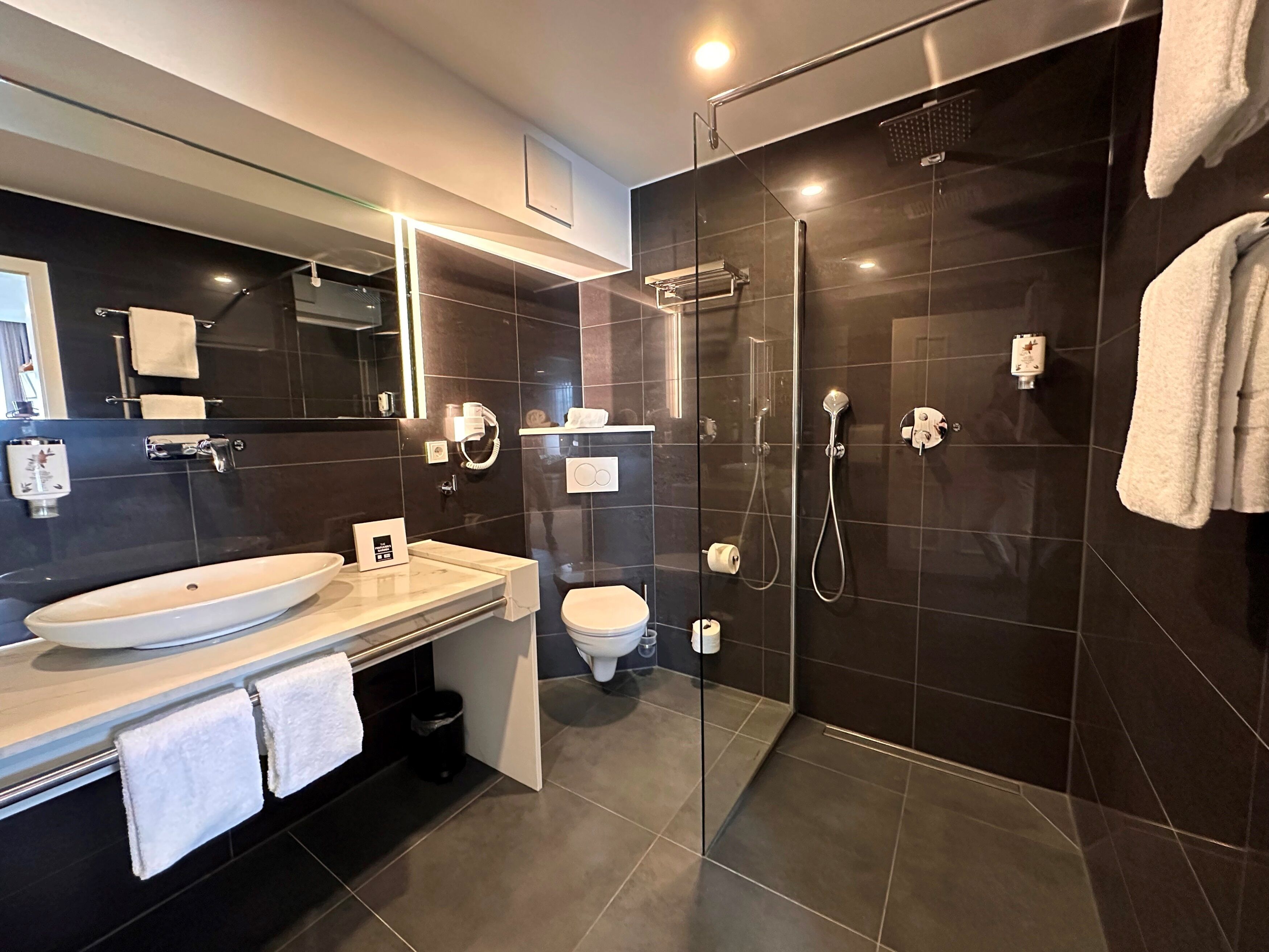 junior studio suite | bathroom | shower, rainfall showerhead, free toiletries, hair dryer