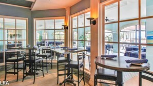 A restaurant with large windows, tables, and chairs. - 411-B Villa Capriani: Ocean Views & Beach Bliss! (North Topsail Beach)