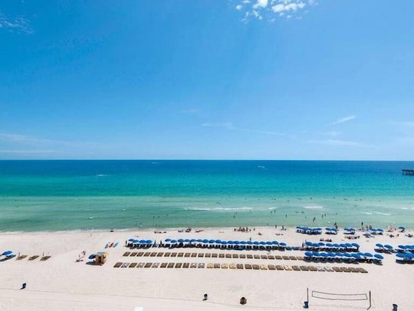 Relax on the beach with rows of comfortable lounge chairs and umbrellas.