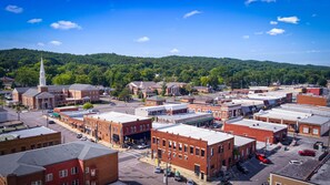 Stroll through the charming town's central square, surrounded by historic buildings and lush green hills.