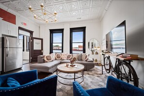 Relax in a stylish room with a large TV, comfortable sofa, and city view.