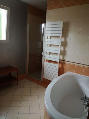 Bathtub, towels, soap, toilet paper