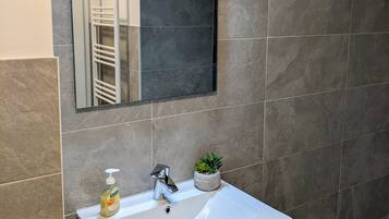 Shower, hair dryer, towels, toilet paper