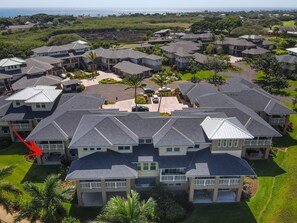 A residential area with multiple two-story houses, each featuring a front porch and a driveway. - Summer Deal Poipu Villa Near Beach with Resort Pool and Hot Tub (Koloa)