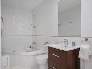 Bathtub, jetted bath, hair dryer, towels