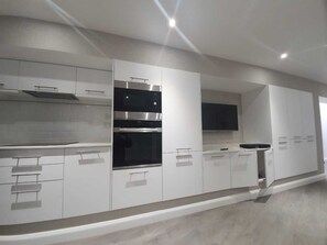 Apartment, Multiple Beds | Private kitchen | Fridge, microwave, oven, stovetop
