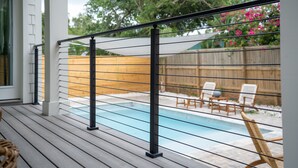 A wooden deck with a pool, a fence, and outdoor furniture. - Brand new 4 bedroom with 2  master suites and pool, steps to the beach. (St. Augustine)