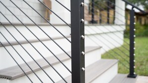 A black metal staircase railing with a white background. - Brand new 4 bedroom with 2  master suites and pool, steps to the beach. (St. Augustine)