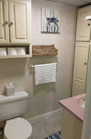 A bathroom with a toilet, sink, and towel rack. - Condo close to beach with pool/ sleeps up to 4 (Ocean City)
