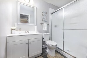 Combined shower/bathtub, towels, soap, toilet paper