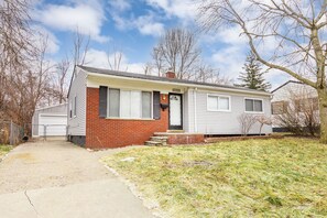 A single-story house with a brick facade and a garage. - Chic, Beautifully Renovated Redford Home! (Redford Charter Township)