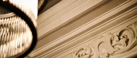 A close-up of a wall with ornate carvings and a light fixture.