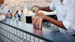A bartender pouring a drink into a copper shaker. - Palazzo Ignazio (Valletta)