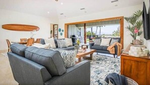 A living room with a sofa, coffee table, and a ceiling fan. - Waikoloa Luxe Golf Estate w/ Hilton Pool passes, Gameroom (Puako)