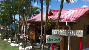 A building with a red roof and a sign that reads "Adeline's Art Cafe" and "Wash Room". - Spacious hideaway with ocean views and fine eatery (00000)