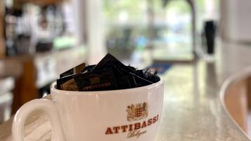A white mug with the text "ATTIBASSI Bologna" on a kitchen counter.