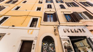 A multi-story building with a storefront labeled "EVENTI". - Serpenti Apartment (Roma)