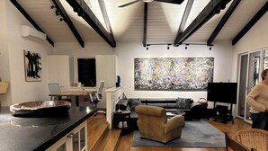 A modern interior with a kitchen, dining area, and living room. -  Gorgeous Chalet in historic San Diego's premier neighborhood- Mission Hills! (San Diego)