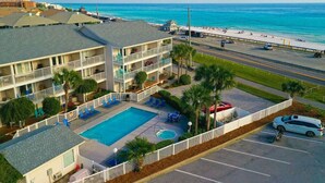 A hotel with a pool, multiple balconies, and a beach view. - End Unit Condo | Beach Views | Pool & Hot Tub (Destin)