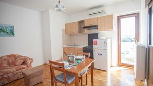 A compact living space with a kitchenette, a dining area, and a sofa. - AGATA One-Bedroom Apartment 4 (Banjole)