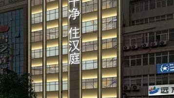 A hotel building with multiple floors and a prominent sign.
