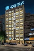 A hotel building with multiple floors and a prominent sign.