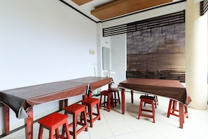 Enjoy meals in this dining area with a long table and matching stools.