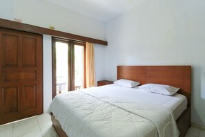 Relax in a spacious room with a large bed and access to an outdoor area.