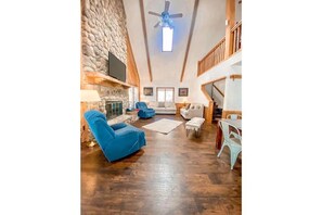 Cozy living area with a fireplace, comfortable seating, and a dining table.