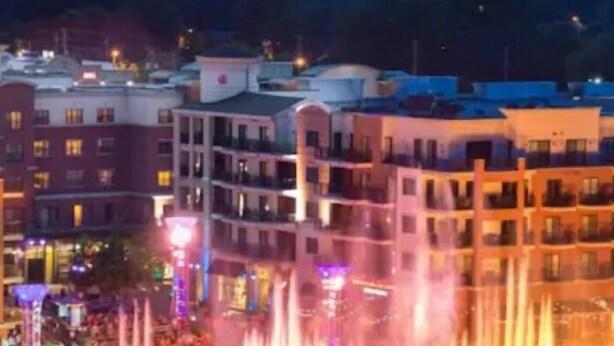 A multi-story hotel with a central courtyard featuring a fountain.