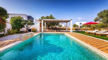 A heated pool, pool loungers