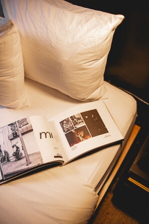 A bed with white bedding and a magazine open on it. - The Clyde Hotel Portland by Kasa Living (Portland)