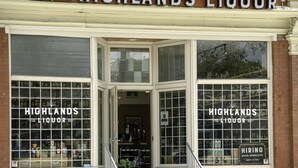 En butik med en skylt som visar texten ”HIGHLANDS LIQUOR”.