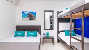 A hotel room with two beds, a nightstand, a mirror, and an air conditioning unit. - Hotel Guajira Azul (Riohacha)