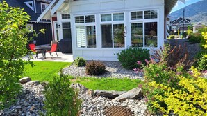 A house with a red roof, white exterior, and large windows. - Steps from the beach and Pool #62 (Osoyoos)