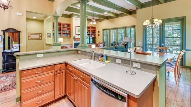 A spacious kitchen with a large island, built-in bookshelves, and a dining area with a view. - 5 Mi to Old Town Bluffton: Cottage w/ Patio (Bluffton)