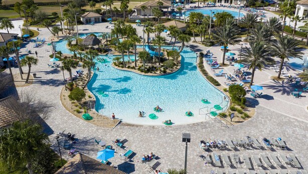 A resort with multiple swimming pools, palm trees, and sun loungers. - Unleash the Fun: 2BR Condo Sleeps 7 with Game Room (Four Corners)