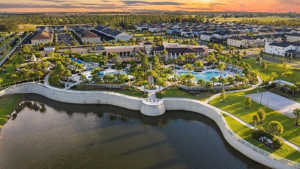 A residential area with houses, a swimming pool, and a park. - Stunning 6-Bed Home - Sleeps 13 at Solara! (Kissimmee)