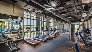 A gym with treadmills, weight machines, and exercise balls. - Stunning 6-Bed Home - Sleeps 13 at Solara! (Kissimmee)
