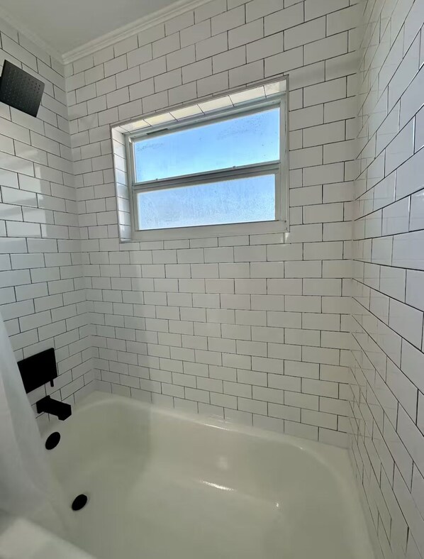 Combined shower/tub, hair dryer, towels, soap