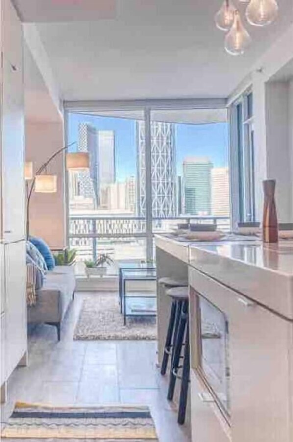 Enjoy meals at the kitchen counter or dining table with a view of the city.
