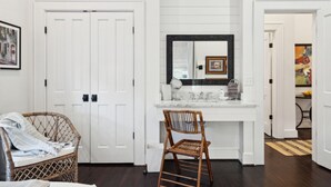 A bathroom with a white vanity, a mirror, and a framed picture above the mirror. - 8B at Saint Philip Square, One Block to King, Spacious Group and Family Favorite (Charleston)