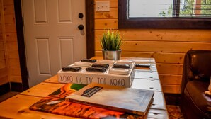 A wooden table with a box labeled "XOXO TIC TAC TOE" and a plant in a metal pot. - SUPER CUTE RUSTIC & CLEAN HOME 40 minutes to YNP (Island Park)