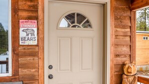 A wooden cabin with a beige door, a bear sculpture, and a sign stating "When you object, it will kill you." - SUPER CUTE RUSTIC & CLEAN HOME 40 minutes to YNP (Island Park)