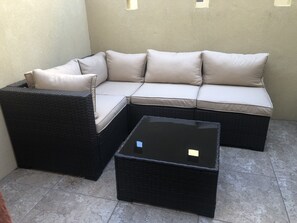 Relax in the cozy corner seating area with a sofa and armchair, perfect for unwinding.