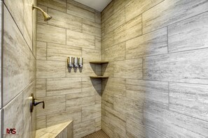 Bathtub, hair dryer, towels, shampoo