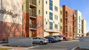 A multi-story apartment building with a parking lot. - Almost-Downtown Condo w/ Fully Stocked Coffee Bar and Private Sauna (Traverse City)