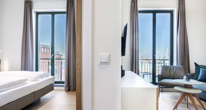 Light-flooded harbor apartment with panoramic view, roof terrace and balcony